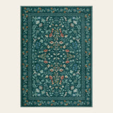 Covaba vintage floral area rug in deep green, shown flat on a plain ivory backdrop