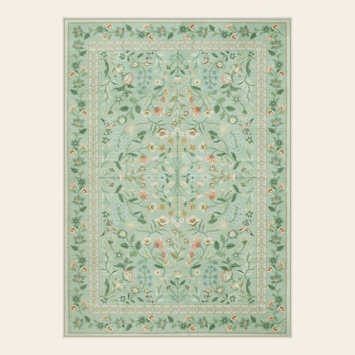 Covaba vintage floral area rug in sage mist, shown flat on a plain ivory backdrop