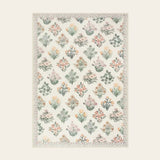 Covaba meadow floral area rug in warm beige, shown flat on a plain ivory backdrop