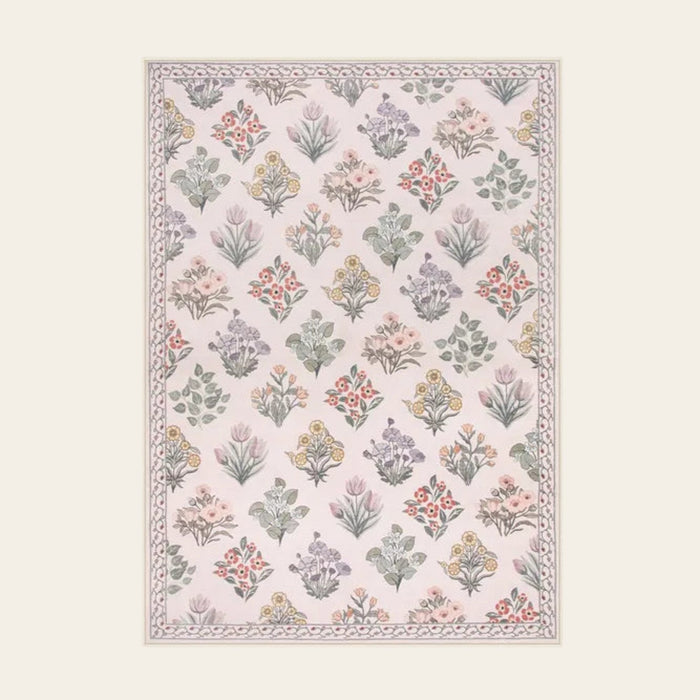 Covaba meadow floral area rug in blush clay, shown flat on a plain ivory backdrop