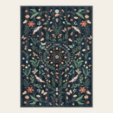 Covaba boho insect botanical floral area rug in ink black, shown flat on a plain ivory backdrop