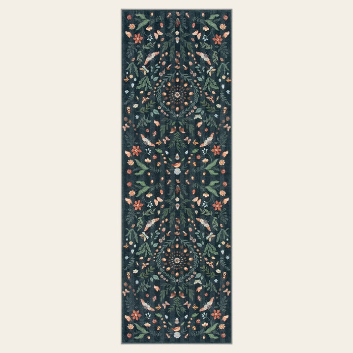 Covaba boho insect botanical floral runner rug in ink black, shown flat on a plain ivory backdrop