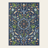 Covaba boho insect botanical floral area rug in stormy blue, shown flat on a plain ivory backdrop