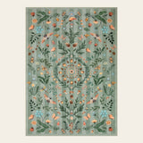Covaba boho insect botanical floral area rug in fern green, shown flat on a plain ivory backdrop