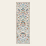 Covaba maximalism vibrant blossom floral runner rug in warm beige, shown flat on a plain ivory backdrop