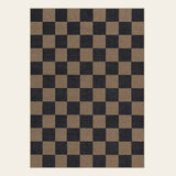 Covaba checkered easy jute indoor/outdoor area rug in coffee brown, shown flat on a plain ivory backdrop