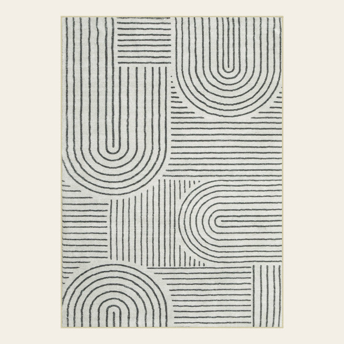 Covaba abstract rainbow stripe black/beige area rug in warm beige, shown flat on a plain ivory backdrop