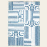 Covaba abstract rainbow stripe blue/white area rug in stormy blue, shown flat on a plain ivory backdrop