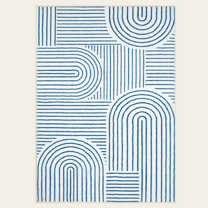 Covaba abstract rainbow stripe blue/white area rug in stormy blue, shown flat on a plain ivory backdrop