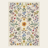 Covaba boho botanical floral area rug in warm beige, shown flat on a plain ivory backdrop