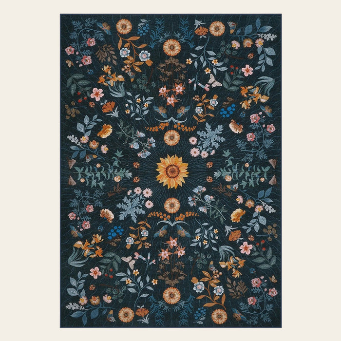 Covaba boho botanical floral area rug in stormy blue, shown flat on a plain ivory backdrop