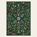 Covaba boho botanical floral area rug in fern green, shown flat on a plain ivory backdrop