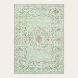 Covaba vintage traditional floral area rug in fern green, shown flat on a plain ivory backdrop
