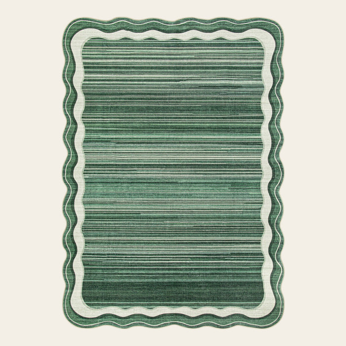 Covaba modern abstract bordered scalloped area rug in fern green, shown flat on a plain ivory backdrop