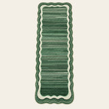 Covaba modern abstract bordered scalloped runner rug in fern green, shown flat on a plain ivory backdrop