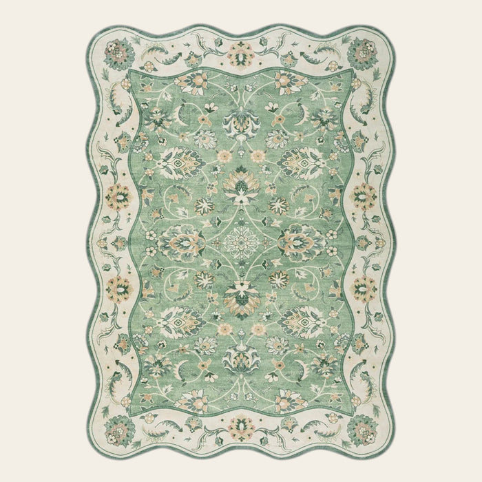 Covaba vintage botanical scalloped area rug in fern green, shown flat on a plain ivory backdrop