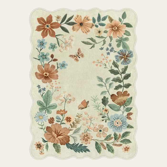 Covaba boho modern parisian floral scalloped area rug in warm beige, shown flat on a plain ivory backdrop