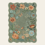 Covaba boho modern parisian floral scalloped area rug in fern green, shown flat on a plain ivory backdrop