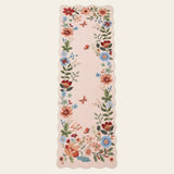 Covaba boho modern parisian floral scalloped runner rug in soft blush, shown flat on a plain ivory backdrop