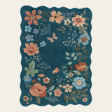 Covaba boho modern parisian floral scalloped area rug in deep navy, shown flat on a plain ivory backdrop