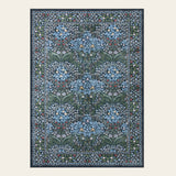 Covaba maximalism vintage french floral area rug in stormy blue, shown flat on a plain ivory backdrop
