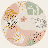 Covaba modern botanical leaf round rug in blush clay, shown flat on a plain ivory backdrop