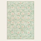 Covaba vintage floral area rug in soft green, shown flat on a plain ivory backdrop