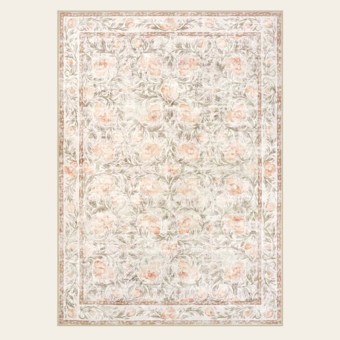 Covaba vintage floral area rug in blush clay, shown flat on a plain ivory backdrop