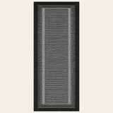 Covaba modern minimalist line runner rug in ink black, shown flat on a plain ivory backdrop