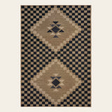 Covaba tribal soft easy jute indoor/outdoor area rug in ink black, shown flat on a plain ivory backdrop