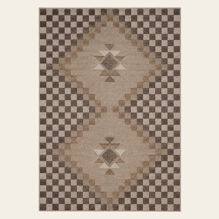 Covaba tribal soft easy jute tan indoor/outdoor area rug in multicolor, shown flat on a plain ivory backdrop