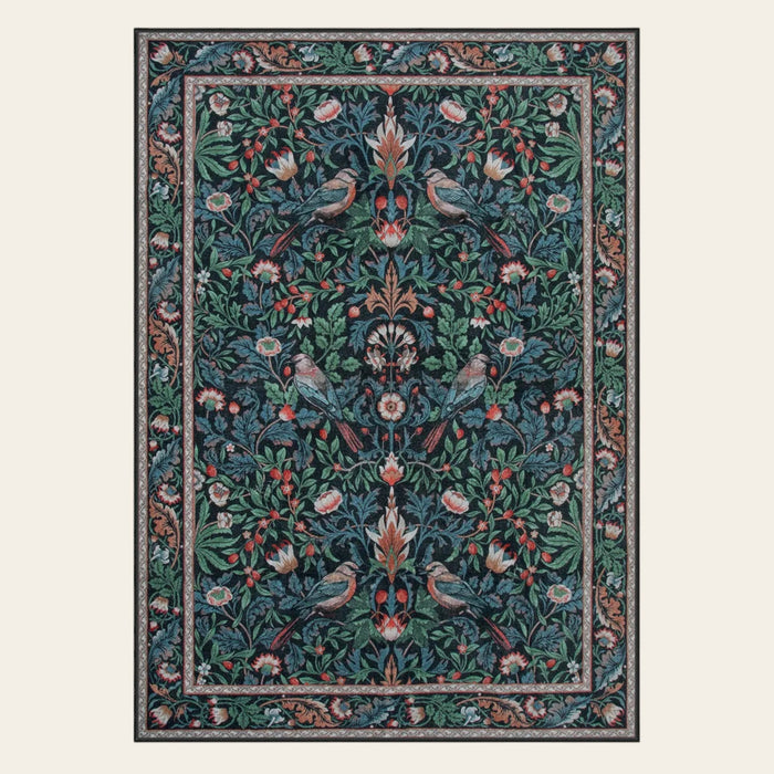 Covaba vintage floral bird royal area rug in stormy blue, shown flat on a plain ivory backdrop