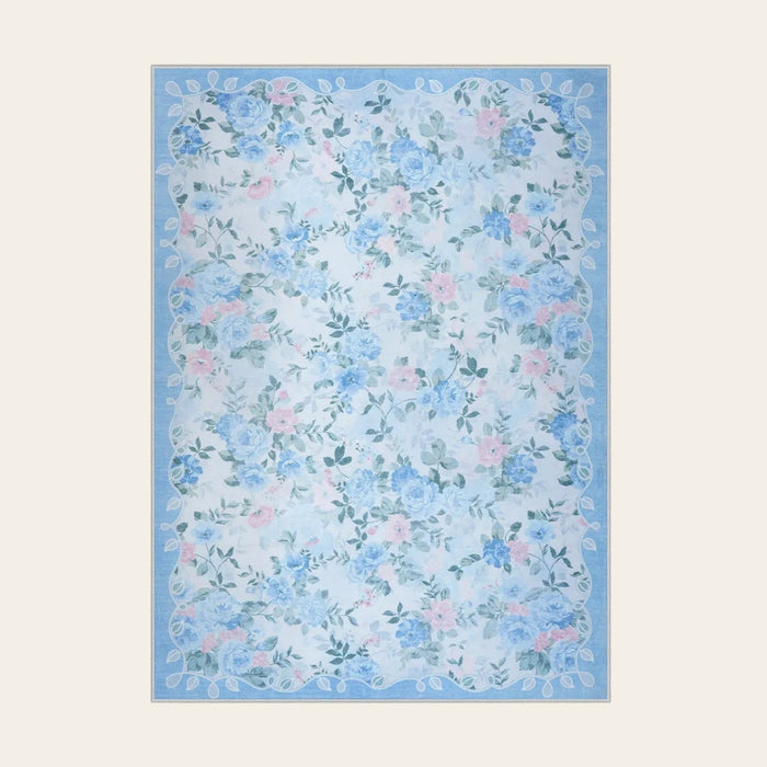Covaba romantic vintage floral rose garden area rug in stormy blue, shown flat on a plain ivory backdrop