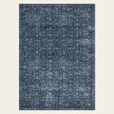 Covaba vintage persian distressed area rug in stormy blue, shown flat on a plain ivory backdrop