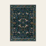 Covaba botanical bird garden chenille area rug in ink black, shown flat on a plain ivory backdrop