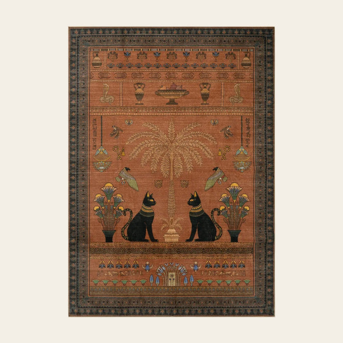 Covaba ancient egyptian revival cat area rug in faded rose, shown flat on a plain ivory backdrop
