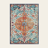 Covaba bohemian floral medallion area rug in amber clay, shown flat on a plain ivory backdrop