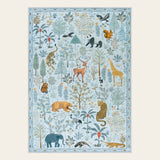 Covaba jungle animals area rug in stormy blue, shown flat on a plain ivory backdrop