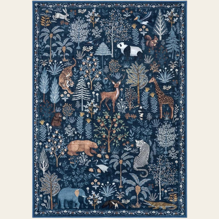 Covaba jungle animals area rug in deep navy, shown flat on a plain ivory backdrop