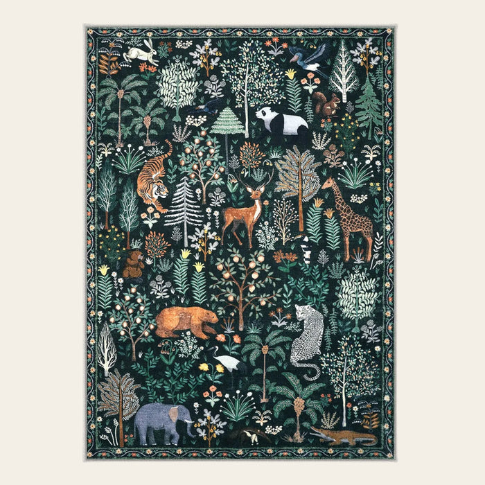 Covaba jungle animals area rug in fern green, shown flat on a plain ivory backdrop