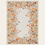 Covaba modern blooming floral garden area rug in golden wheat, shown flat on a plain ivory backdrop