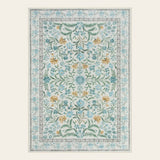 Covaba boho modern parisian garden floral area rug in stormy blue, shown flat on a plain ivory backdrop