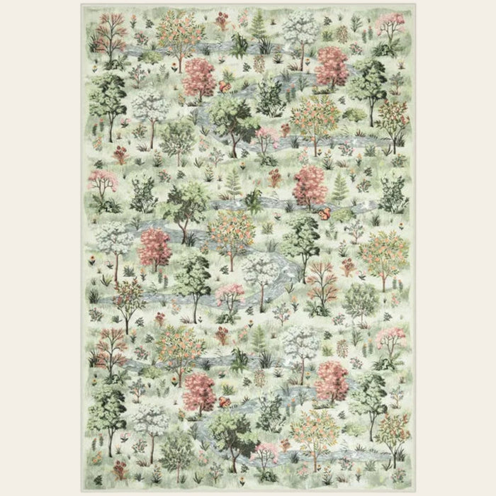 Covaba forest woodland area rug in sage mist, shown flat on a plain ivory backdrop