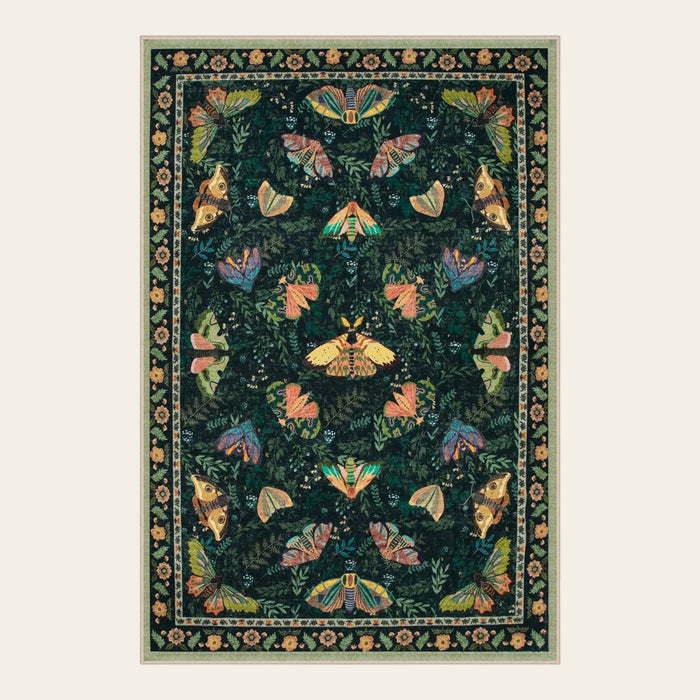 Covaba vintage botanical insect area rug in fern green, shown flat on a plain ivory backdrop
