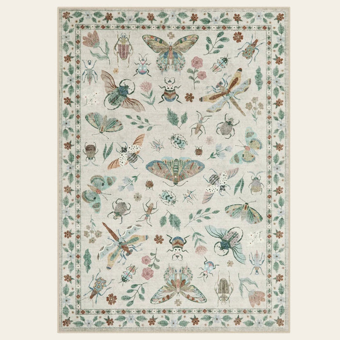 Covaba modern parisian insect area rug in warm beige, shown flat on a plain ivory backdrop