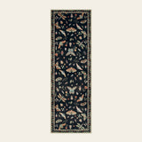 Covaba modern parisian insect runner rug in ink black, shown flat on a plain ivory backdrop