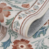 Covaba maximalism vibrant blossom floral rug in warm beige, styled in a room setting