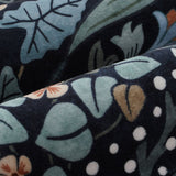 Covaba maximalism vibrant blossom floral rug in ink black, styled in a room setting, view 2