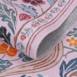 Covaba maximalism vibrant blossom floral rug in blush clay, styled in a room setting, view 2
