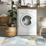 Covaba modern botanical leaf rug in stormy blue, styled in a room setting